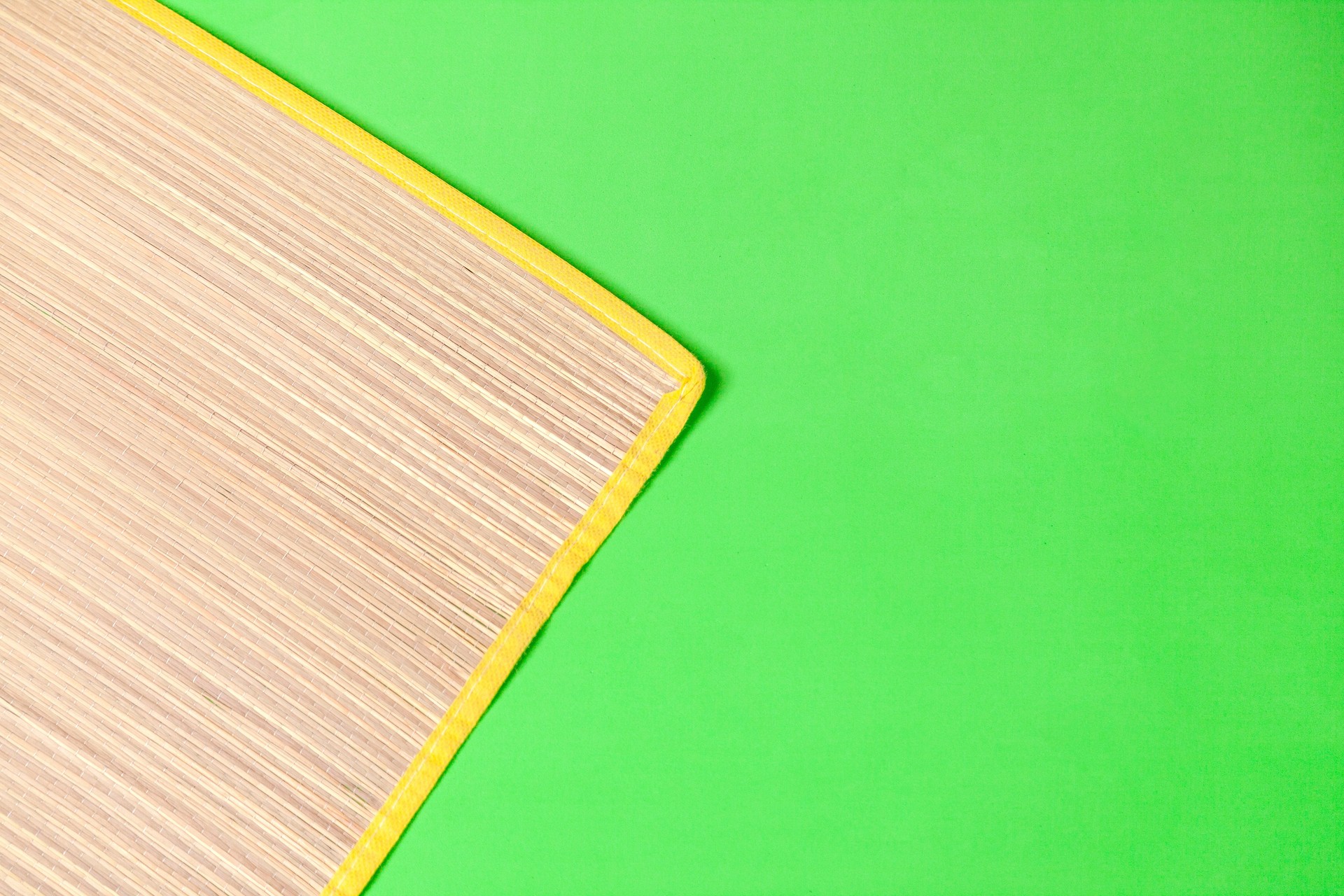 Straw mat on green background.