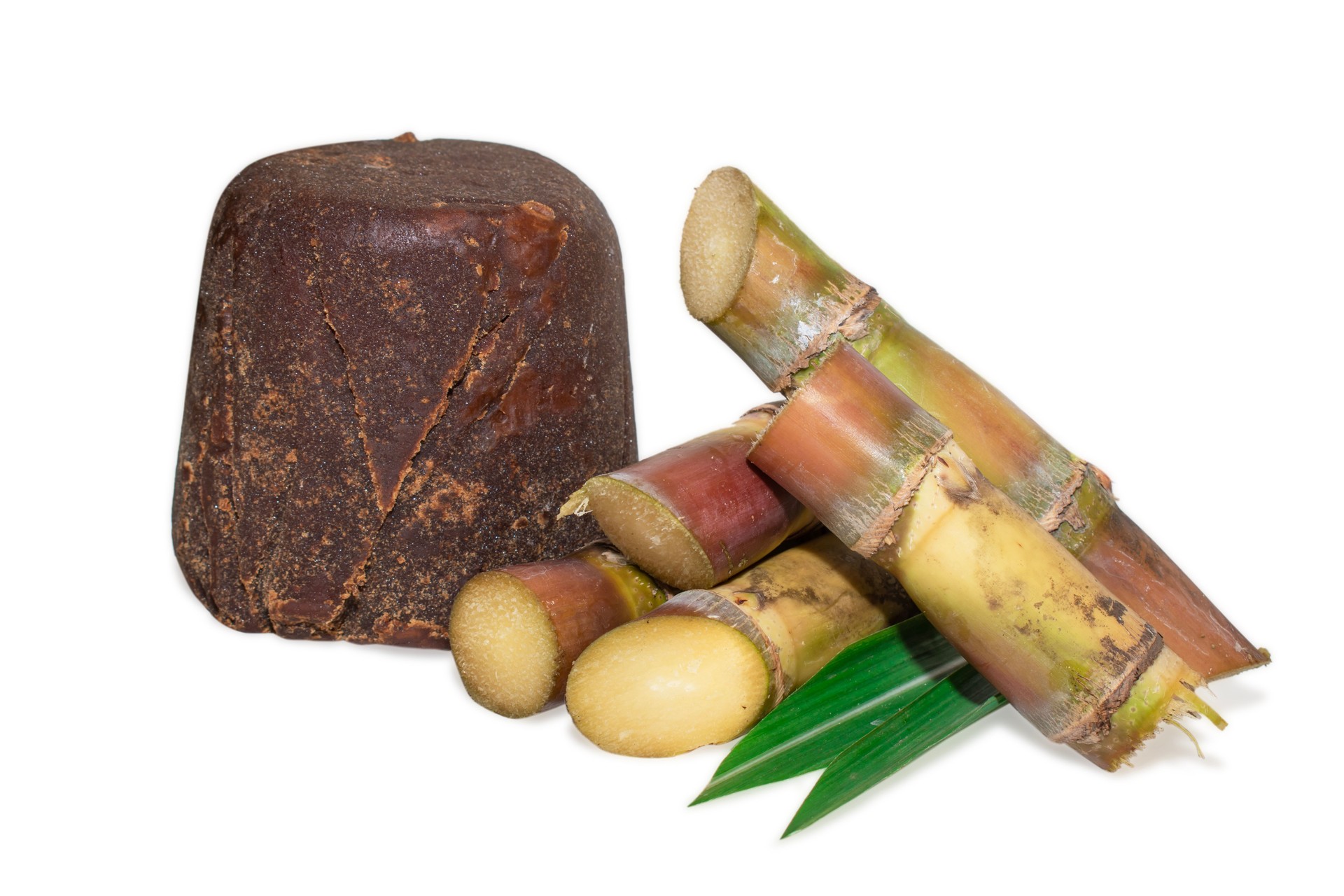 Organic Jaggery ( unrefined sugar ) and sugarcane isolated on white background.