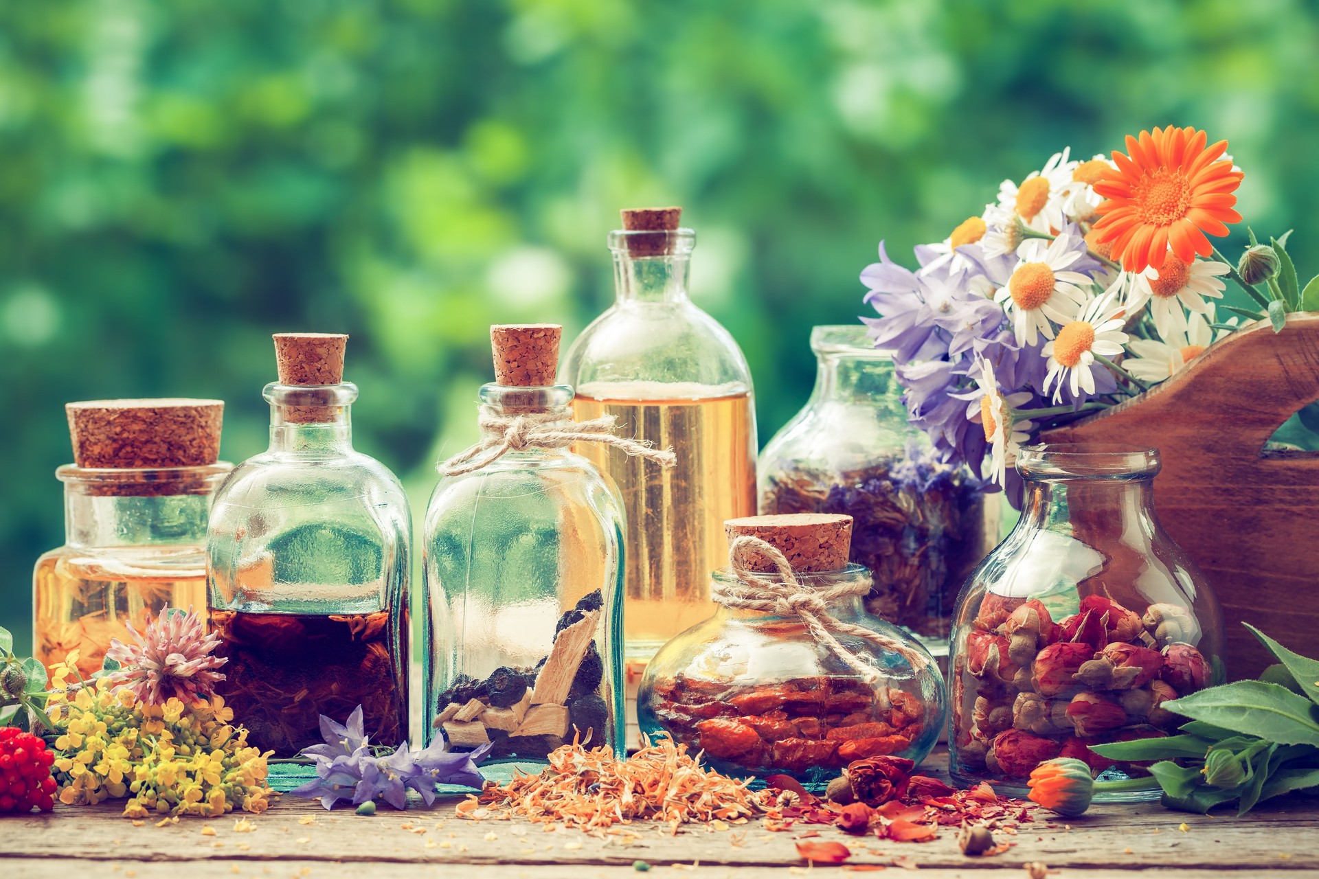 Bottles of tincture or potion and dry healthy herbs