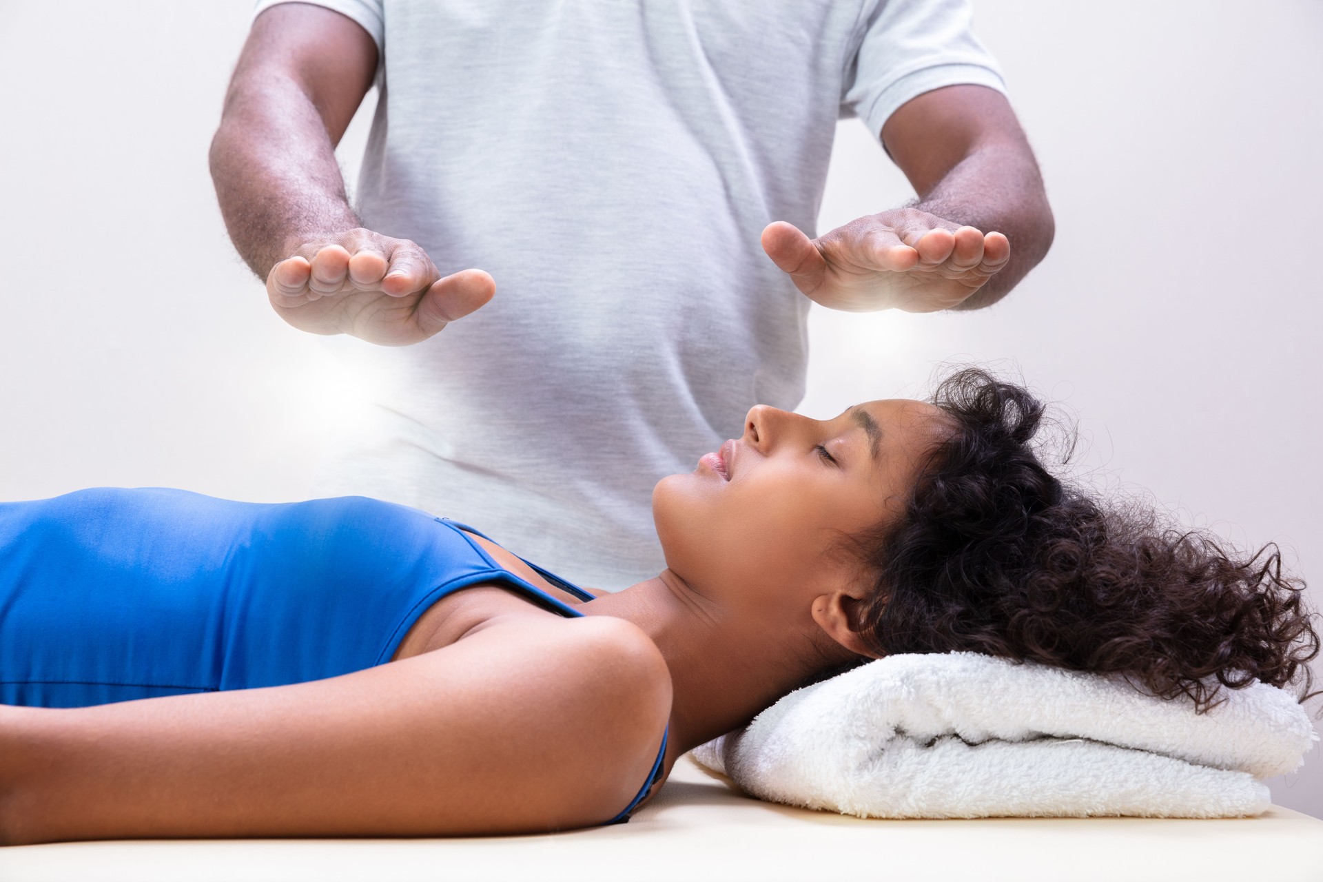 Woman Having Reiki Healing Treatment
