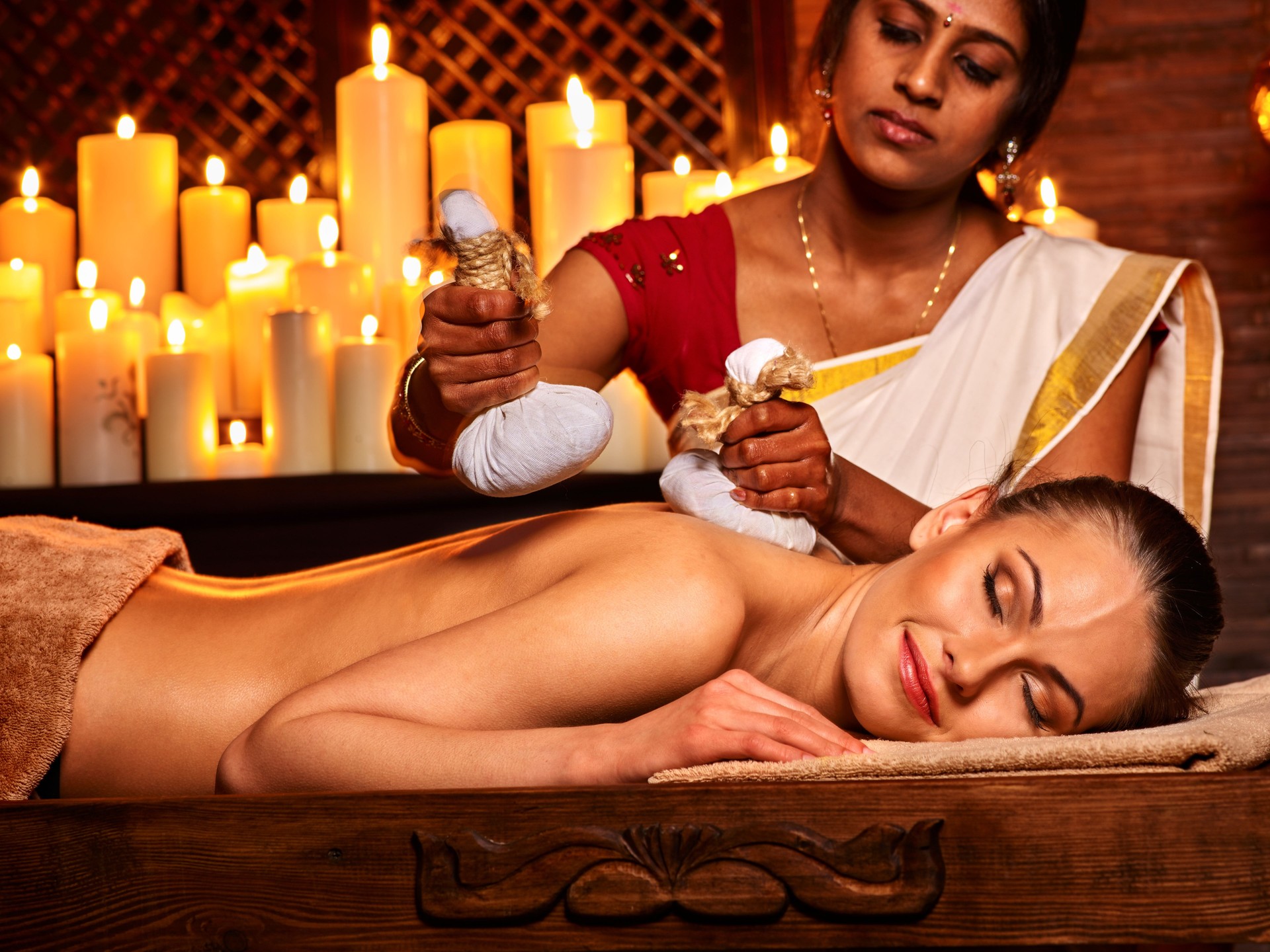 Woman having massage with pouch of rice